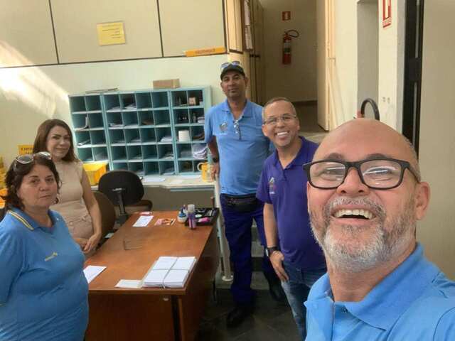 Diretoria com trabalhadores na área de distribuição de uma unidade